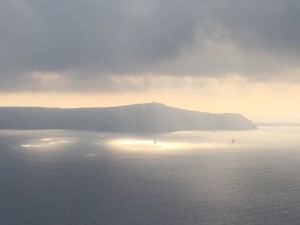 A sudden sun burst through the clouds in the bay of Santorini