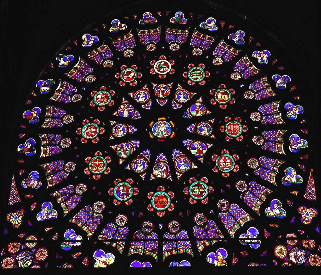 The North Rose Window of The Saint Denis Cathedral is called, "The Creation." "God the Creator," is in the center surrounded by "The Days of Creation." These are surrounded by each of the twelve signs of the Zodiac, which represent "The Order of the Heavens." Next, the "Labor of the Months" depict the "Order of Earth." In each corner outside of this circle of life are images of the "Fall of Mankind."  Originally constructed c. 1145, repaired 1805. Paris, France. 