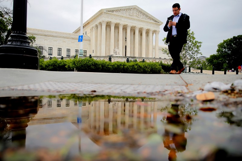 A pedestrian walks in front of the U S Supreme Court building in Washington U S May 19 2016 <br/>REUTERS Carlos Barria
