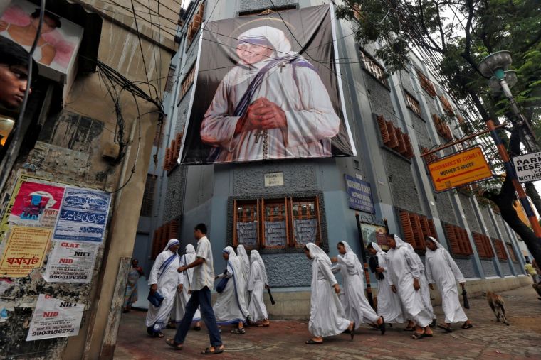 nuns-belonging-to-the-global-missionaries-of-charity-walk-past-a-large-banner-of-mother-teresa-ahead-of-her-canonisation-ceremony-in-kolkata-india-today